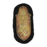 A German Third Reich Narvik Shield, Gold Class, Kriegsmarine, with black wool backing, the reverse