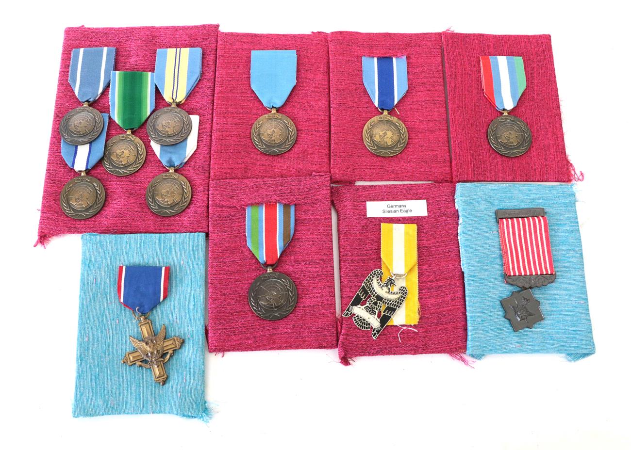 A US Distinguished Service Cross, un-numbered, with ribbon; Thailand - a Freemen Safeguarding Medal,