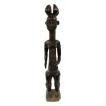 A 20th Century Attye Large Carved Wood Figure of a Woman, Ivory Coast, standing with four horned