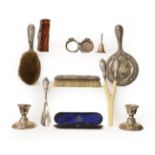 A tray of silver items including a pair of dwarf candlesticks, silver mounted spectacles case and