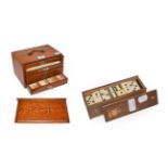 An oak cased Chinese mahjong set and a box of ebony and bone dominoes . Composite tiles.