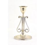 A Victorian Silver Candlestick, by George Howson, London, 1897 on an oval base, the stem formed as a