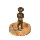 Early 20th century bronze of a child with sponge on an onyx dish base, 18cm diameter, 20cm high