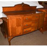 An early 20th century mahogany bow-front sideboard raised on cabriole legs, 152cm by 57cm by 120cm