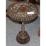 A Steampunk Industrial metal tripod table, constructed using various industrial sprockets, gears,