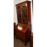 An Edwardian mahogany bureau bookcase, with astragal glazed top section, cross banded in