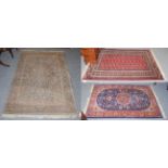 A Lohore Bukhara rug, the crimson field with two columns of guls enclosed by multiple borders
