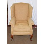 A mahogany framed wing back chair on ball and claw feet
