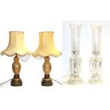 A pair of satin glass table lamps with gilt decoration and raised on pierced brass plinths, together