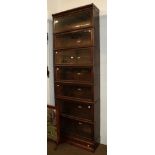 A large Globe Wernicke oak seven-sectioned bookcase, 86cm by 29cm by 257cm