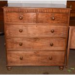 A Victorian mahogany chest of drawers with turned handles and raised on turned feet, 108cm by 52cm