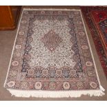 A machine made rug of Kashmir design the ivory field with central medallion, 179cm by 128cm
