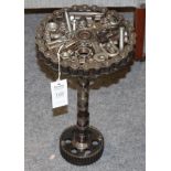A Steampunk Industrial metal tripod table, constructed using various industrial sprockets, gears,
