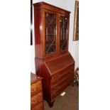 An Edwardian mahogany and satinwood banded bureau bookcase with geometric astragal glazed doors