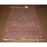 A Hamadan rug, the madder lattice field with central diamond medallion enclosed by triple borders,