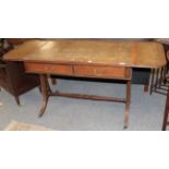 An early 20th century mahogany leather topped two drawer sofa table with reeded sabre supports and