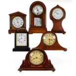 An inlaid timepiece retailed by Harrods Ltd, four other mantel mahogany timepieces, and an