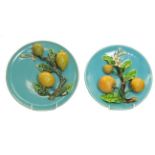 A pair of 19th century Continental Majolica wall plaques applied with fruit, 25cm diameter. In