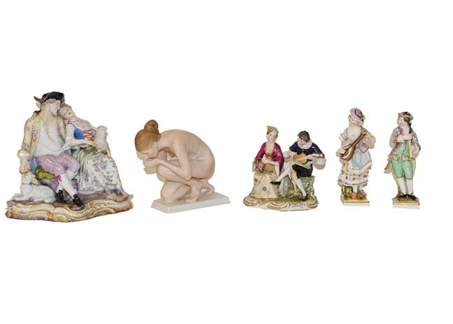 A tray of Continental porcelain figures including a Meissen style figure of a seated shepherd and