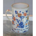 An 18th century Chinese Imari tankard, with reeded strap handle and painted with flowering trees,