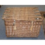 A large wicker hamper with carrying handles, 83cm by 65cm by 55cm
