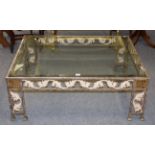 A modern patinated metal and glass coffee table with scrolling leaf and Greek key decoration 117cm