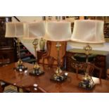 A set of four modern table lamps with silvered standards and gilt stylised petal decoration each