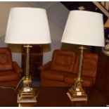 A pair of gilt brass columnar table lamps with silk shades, 52cm