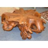 A burr yew wood coffee table, the base surmounted by six carved galloping horses, 120cm by 110cm by