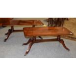 A pair of reproduction cross banded mahogany coffee tables, 99cm by 43cm by 43cm each
