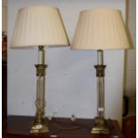 A pair of glass and gilt metal Corinthian columnar table lamps with silk shades, 62cm high