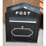 A modern black painted cask metal postbox, 42cm by 20cm by 52cm