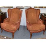 A pair of modern French upholstered wingback chairs by Joanna Marco interiors . Stained beech