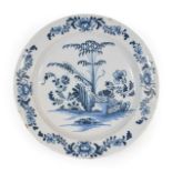 An English Delft Charger, probably Liverpool, circa 1750, painted in blue with bamboo,