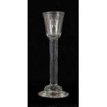 A Cordial Glass, circa 1750, the rounded funnel bowl on a tall plain stem and domed foot, 17.