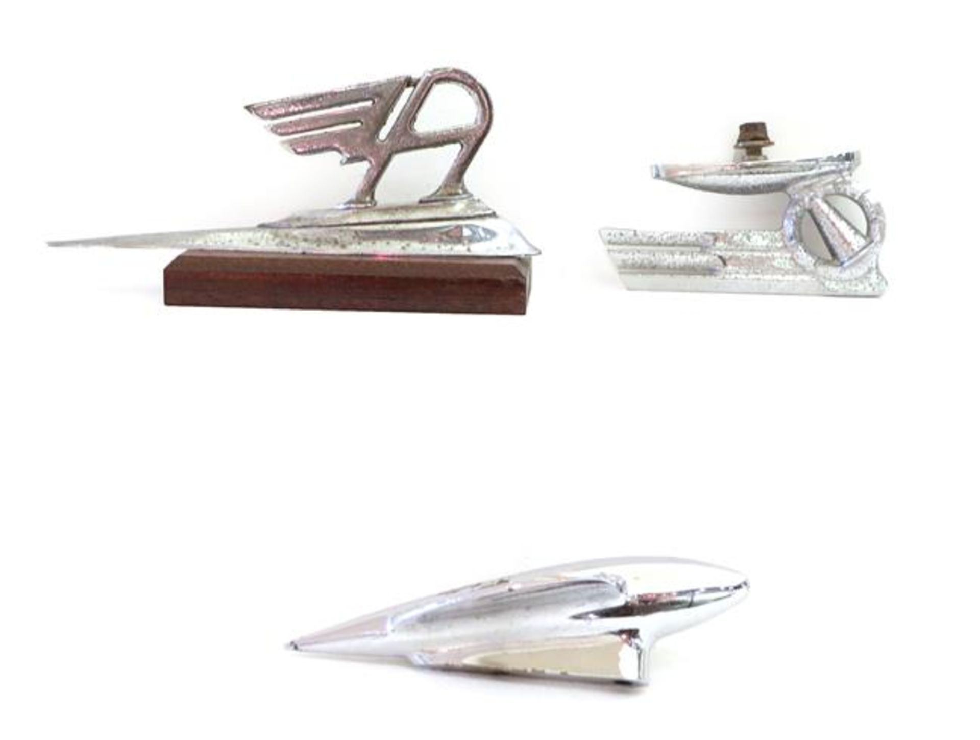 Three 1930's Chromed Stylised Car Mascots, comprising a torpedo shaped example, 18cm long, another