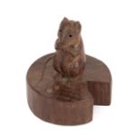 Robert Mouseman Thompson (1876-1955): An English Oak Mouse on a Wedge, the mouse carved on it's