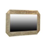 A Scottish Arts & Crafts Rectangular Patinated Metal Mirror, bevelled plate within repoussé