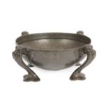 Oliver Baker for Liberty & Co: A Tudric Pewter Bowl, model 067, the hammered bowl on four trefoil