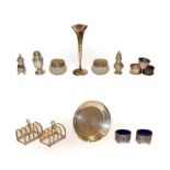 A collection of assorted silver, including three various napkin-rings, a pair of five bar toast