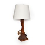 An Arts and Crafts carved oak table lamp