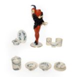 A Hutschereuther porcelain figure of Mephistopheles and a Luneville pottery part doll's tea service,
