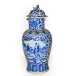 A 19th century Chinese blue and white vase and cover, painted in underglaze blue with panels of