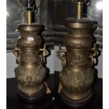 A pair of near Eastern brass lamps, of archaistic form