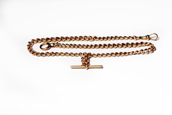 An Albert chain, each link stamped '9' and '.375', length 49.5cm . One clip a gilt metal