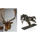 A bronzed and resin figure of a racehorse, together with a taxidermy specimen of a deer head (2)