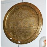 A Persian brass charger depicting Darius the Great, 80cm diameter