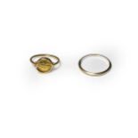 A band ring, stamped '750', finger size S1/2; and a token ring, stamped '750', finger size L (a.f.).