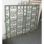 A Victorian green painted wrought iron gate decorated with scroll work, 122cm by 115cm