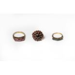 A 9 carat gold garnet cluster ring, finger size M; a 9 carat gold sapphire five stone ring, finger